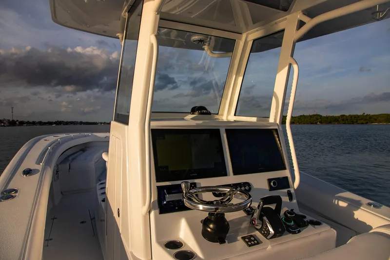 Slide: The Image of 2026 Yellowfin 36 Offshore boat cockpit with modern navigation system at sunset. - 44