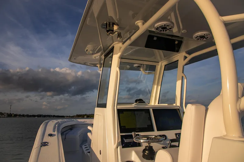 Slide: The Image of 2026 Yellowfin 36 Offshore boat console with modern navigation equipment at sunset. - 45