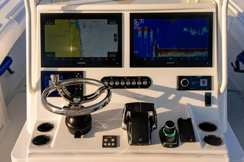 Slide: The Image of 2026 Yellowfin 36 Offshore boat dashboard with Garmin navigation displays and controls. - 48