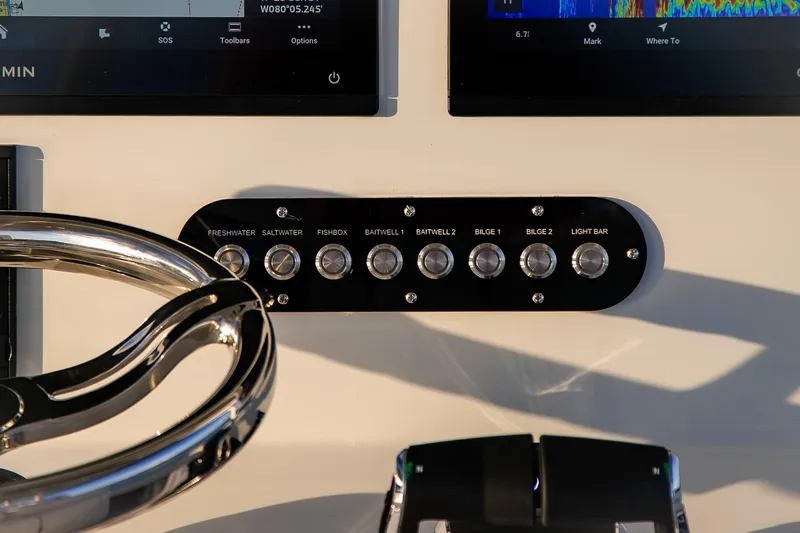 Slide: The Image of Control panel of 2026 Yellowfin 36 Offshore boat with steering wheel and switches. - 49