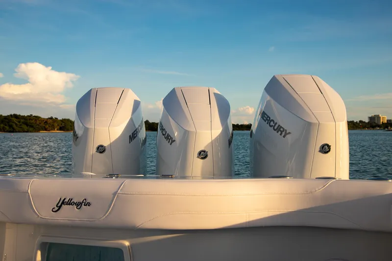 Slide: The Image of 2026 Yellowfin 36 Offshore boat with triple Mercury engines on a serene water backdrop. - 5