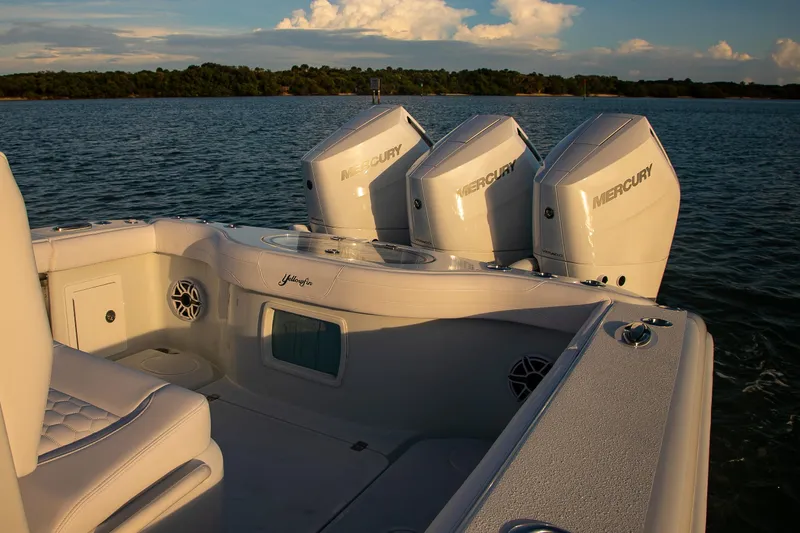 Slide: The Image of 2026 Yellowfin 36 Offshore boat with triple Mercury engines on calm water. - 6