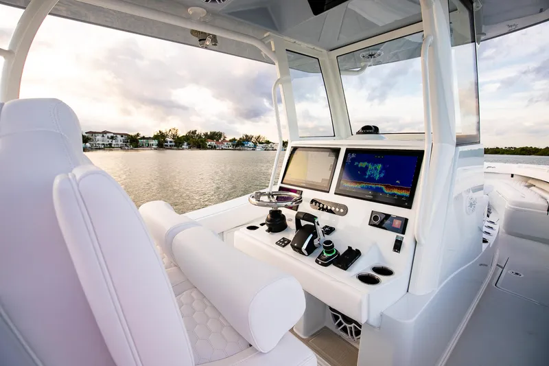 Slide: The Image of 2026 Yellowfin 36 Offshore boat cockpit with advanced navigation systems on a serene water backdrop. - 60