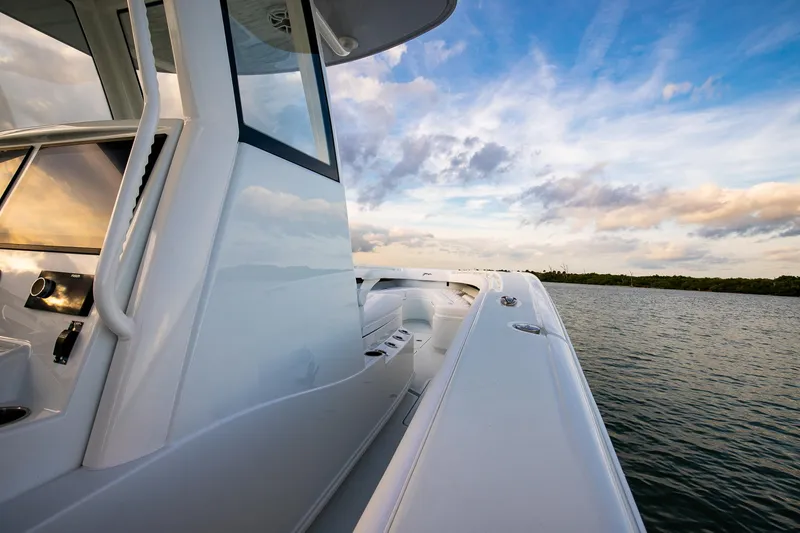 Slide: The Image of 2026 Yellowfin 36 Offshore boat on calm water under a vibrant sky. - 61