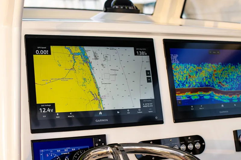 Slide: The Image of 2026 Yellowfin 36 Offshore boat with advanced Garmin navigation displays. - 62