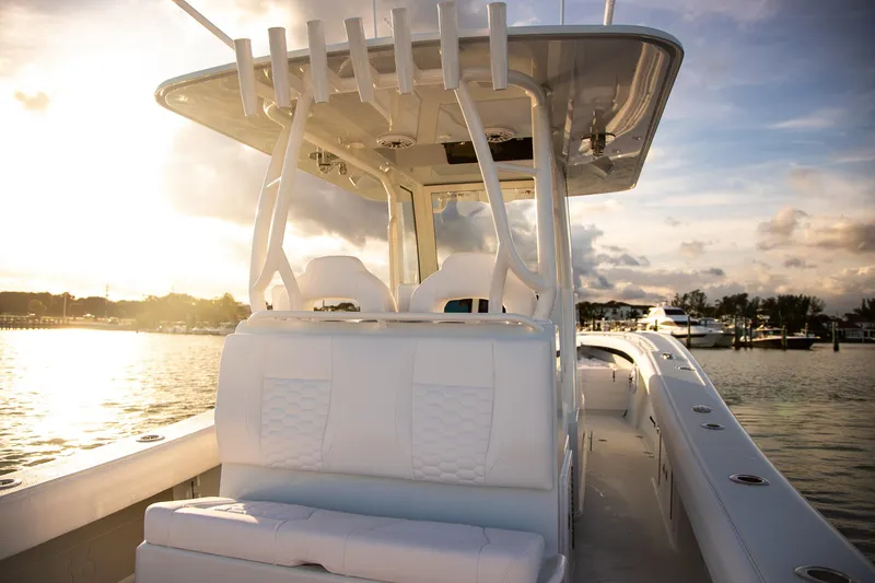 Slide: The Image of 2026 Yellowfin 36 Offshore boat interior at sunset, showcasing luxury seating and design. - 7