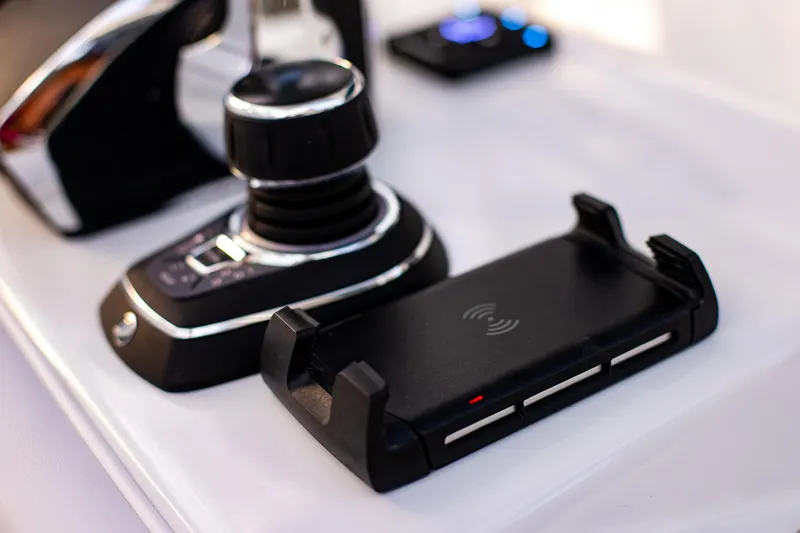 Slide: The Image of Control panel of 2026 Yellowfin 36 Offshore boat with joystick and wireless charger. - 70