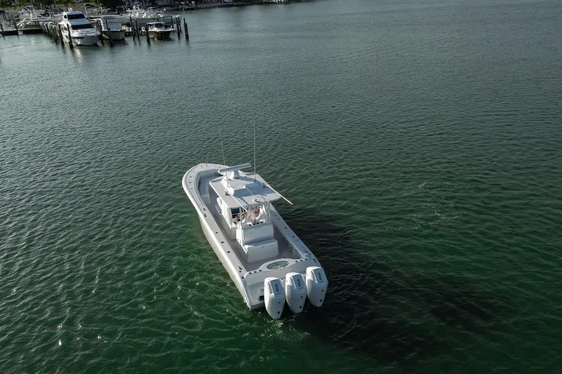 Slide: The Image of 2026 Yellowfin 36 Offshore boat cruising on calm waters near a marina. - 76