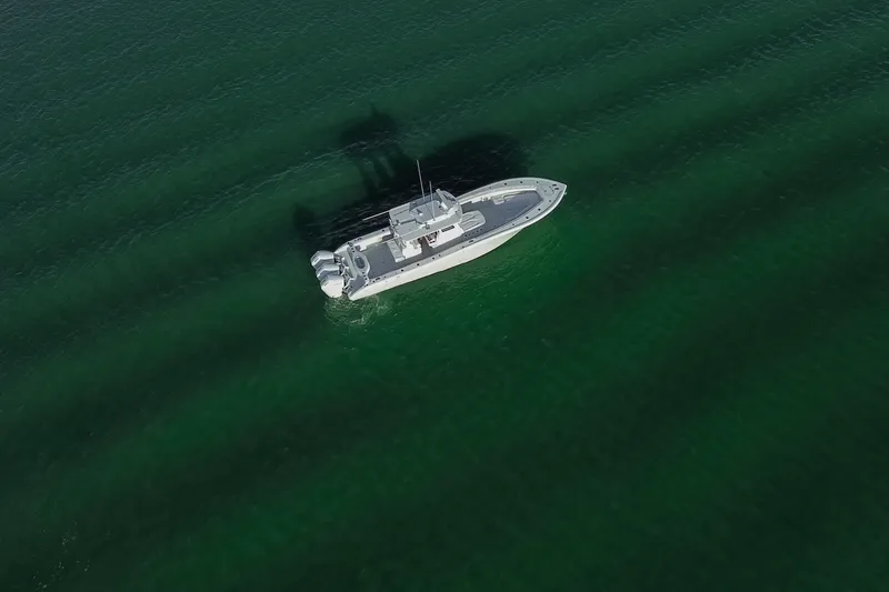 Slide: The Image of Aerial view of 2026 Yellowfin 36 Offshore boat on calm green water. - 78