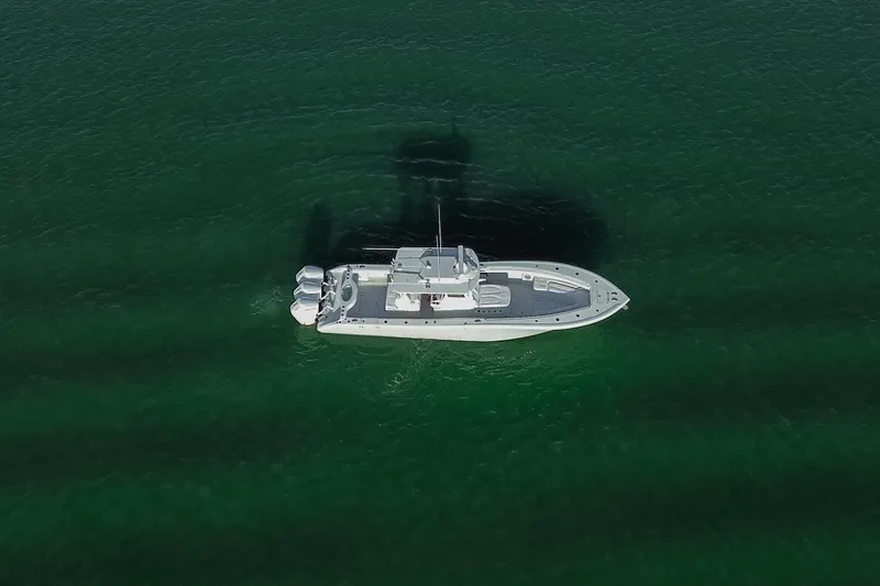 Slide: The Image of Aerial view of 2026 Yellowfin 36 Offshore boat on clear green water. - 79