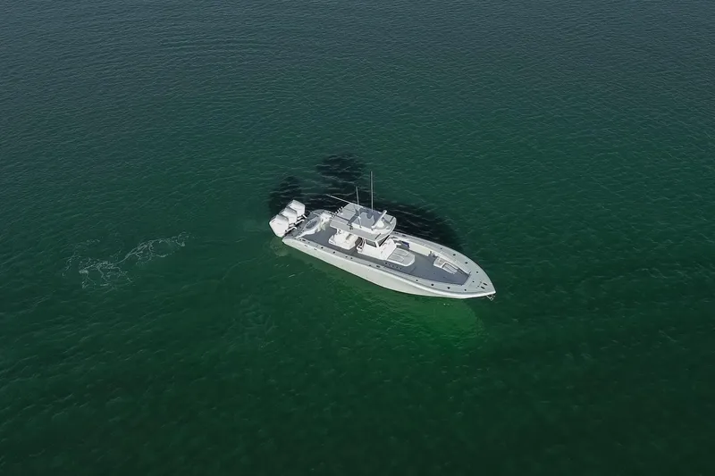 Slide: The Image of Aerial view of 2026 Yellowfin 36 Offshore boat on calm green water. - 80