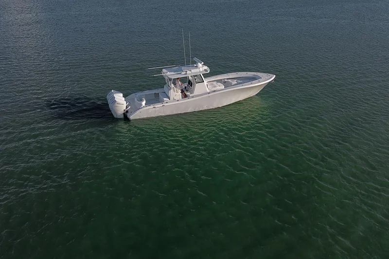 Slide: The Image of 2026 Yellowfin 36 Offshore boat on calm green water. - 84