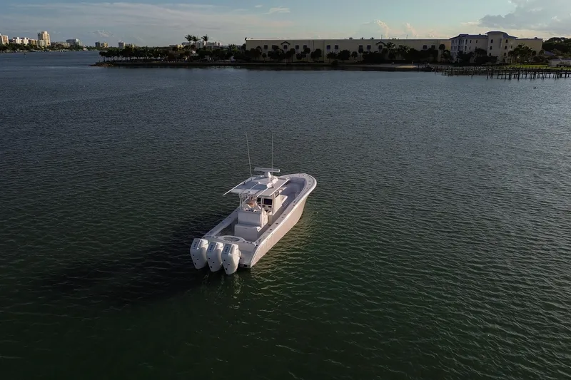 Slide: The Image of 2026 Yellowfin 36 Offshore boat on calm water, distant shoreline view. - 86