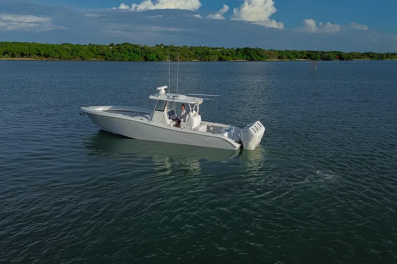 Slide: The Image of 2026 Yellowfin 36 Offshore boat cruising on calm waters under a clear sky. - 91
