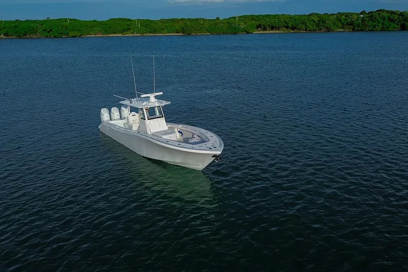 Slide: The Image of 2026 Yellowfin 36 Offshore boat on calm water, surrounded by lush greenery. - 96