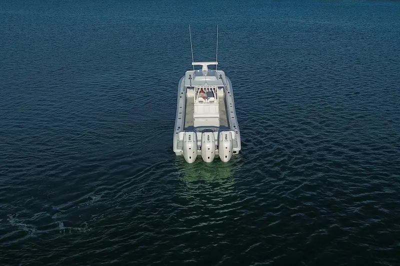 Slide: The Image of 2026 Yellowfin 36 Offshore boat on calm blue water, rear view. - 99