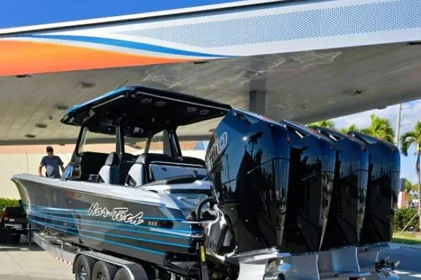 Slide: The Image of 2025 Nor-Tech 400 Supersport boat with four powerful engines at a marina. - 7