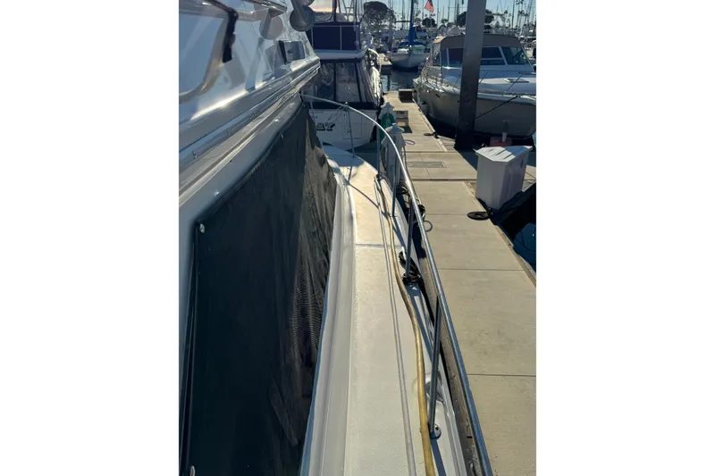 Slide: The Image of 1990 Sea Ray 380 Aft Cabin yacht docked at marina, side view. - 10