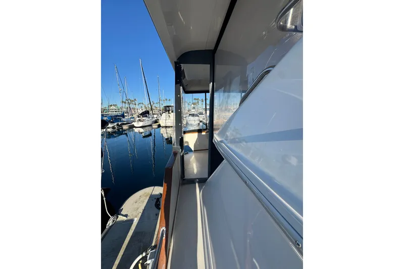 Slide: The Image of 1990 Sea Ray 380 Aft Cabin yacht docked at marina, clear blue sky. - 15