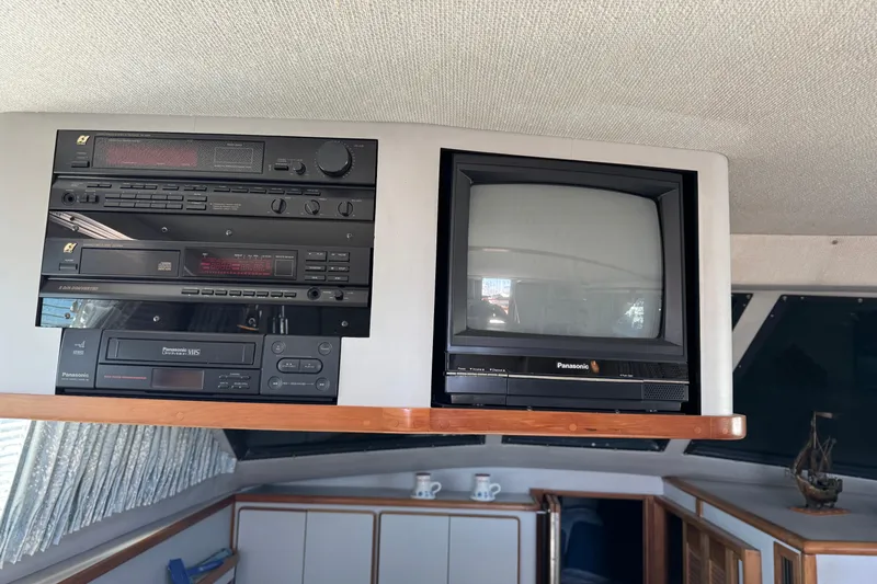 Slide: The Image of 1990 Sea Ray 380 Aft Cabin interior with vintage Panasonic TV and audio system. - 22