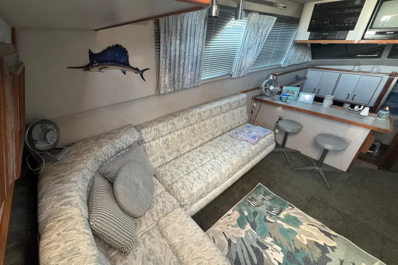 Slide: The Image of Interior of 1990 Sea Ray 380 Aft Cabin with cozy seating and nautical decor. - 24