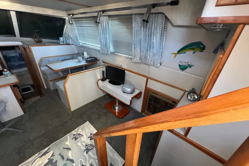 Slide: The Image of Interior of 1990 Sea Ray 380 Aft Cabin with dining area and decor. - 25