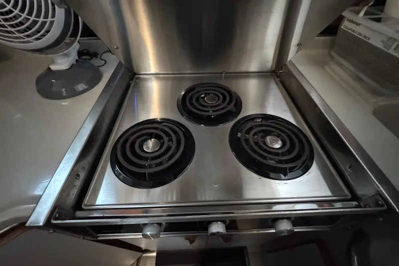 Slide: The Image of Stainless steel stove with three burners on 1990 Sea Ray 380 Aft Cabin yacht. - 32