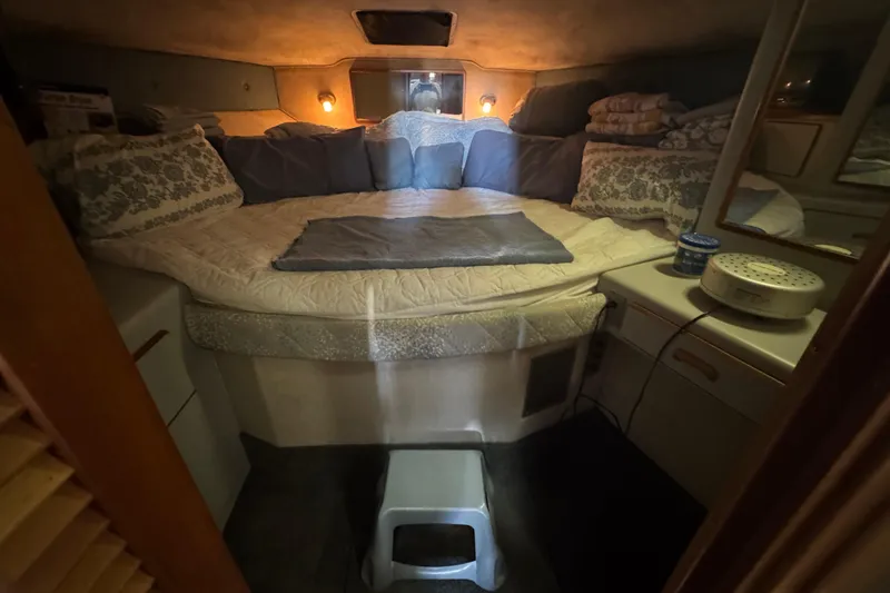 Slide: The Image of Cozy 1990 Sea Ray 380 Aft Cabin bedroom with soft lighting and plush bedding. - 39