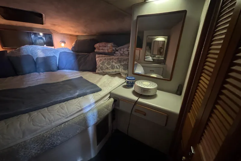 Slide: The Image of Cozy cabin interior of 1990 Sea Ray 380 Aft Cabin with bed and mirror. - 41