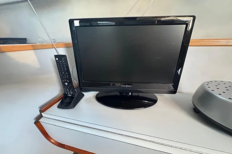 Slide: The Image of TV and remote on Sea Ray 380 Aft Cabin yacht, 1990 model. - 43