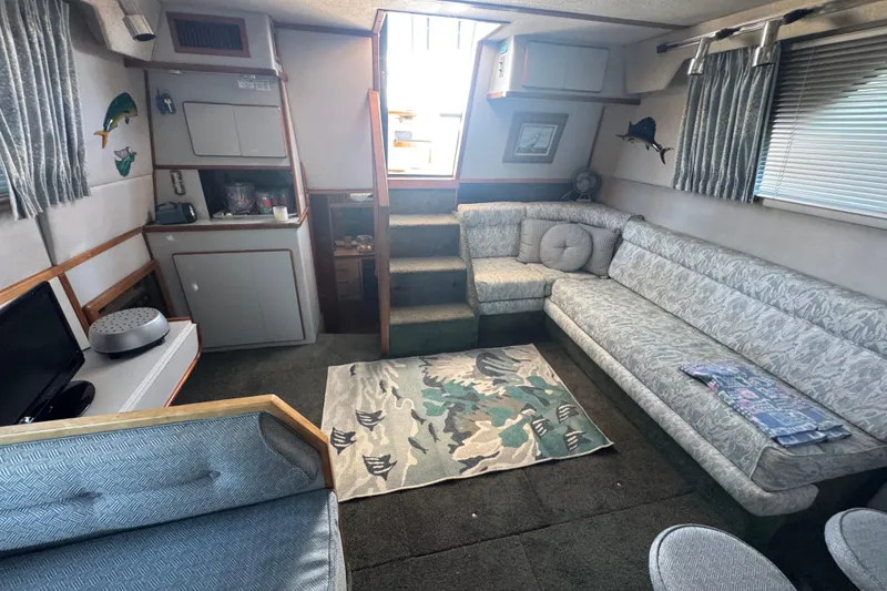 Slide: The Image of Interior of 1990 Sea Ray 380 Aft Cabin with cozy seating and nautical decor. - 45