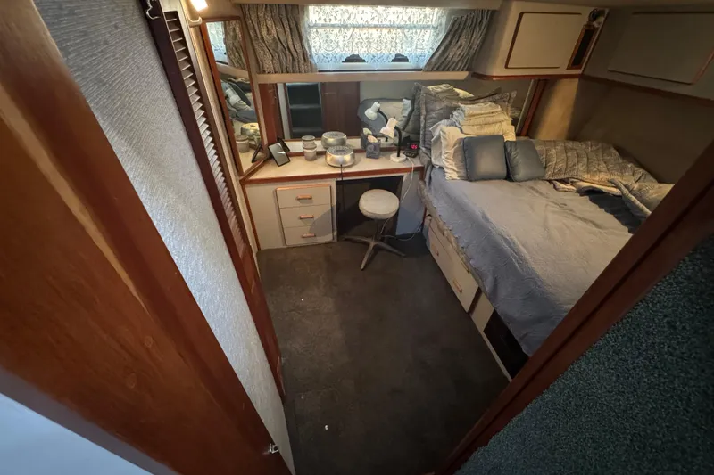 Slide: The Image of Cozy bedroom in 1990 Sea Ray 380 Aft Cabin with bed, desk, and decor. - 47