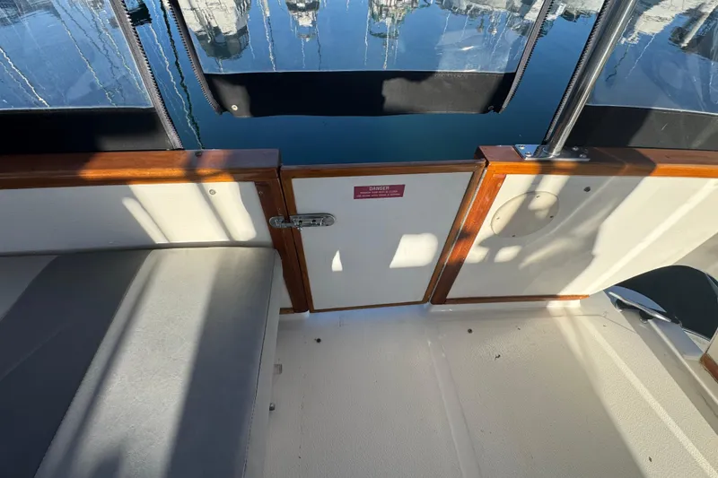 Slide: The Image of 1990 Sea Ray 380 Aft Cabin boat interior with seating and wooden accents. - 55