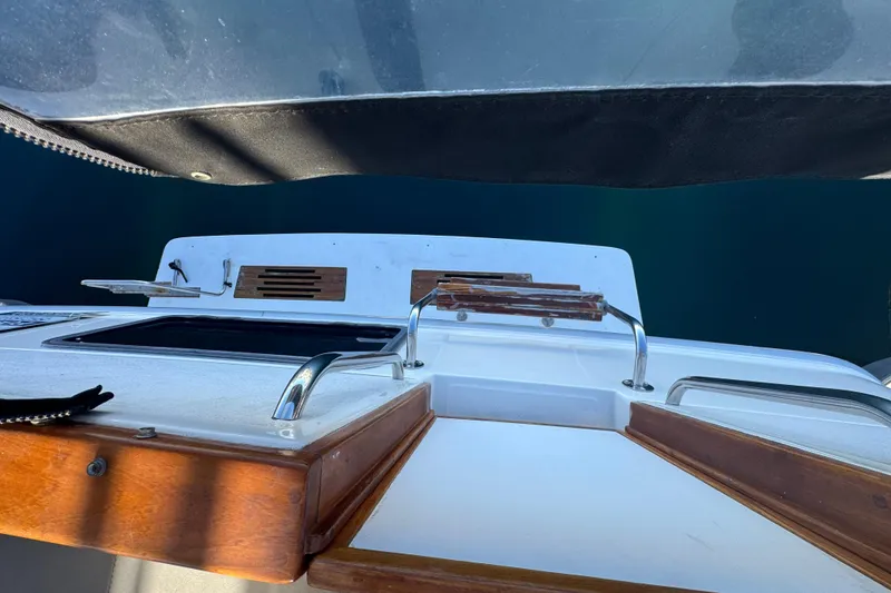 Slide: The Image of 1990 Sea Ray 380 Aft Cabin boat deck with wooden accents and chrome railings. - 56