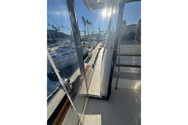 Slide: The Image of 1990 Sea Ray 380 Aft Cabin yacht docked in sunny marina with palm trees. - 57