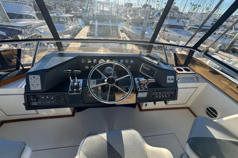 Slide: The Image of Cockpit of 1990 Sea Ray 380 Aft Cabin yacht with steering wheel and controls. - 61