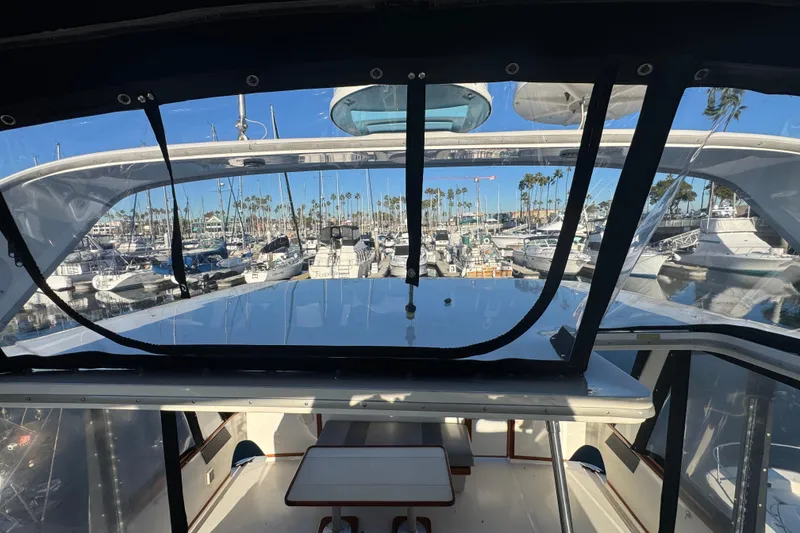 Slide: The Image of 1990 Sea Ray 380 Aft Cabin yacht interior view at marina with boats and palm trees. - 63