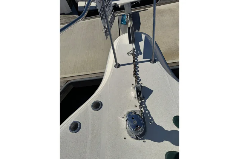 Slide: The Image of 1990 Sea Ray 380 Aft Cabin boat deck with anchor chain and winch. - 69