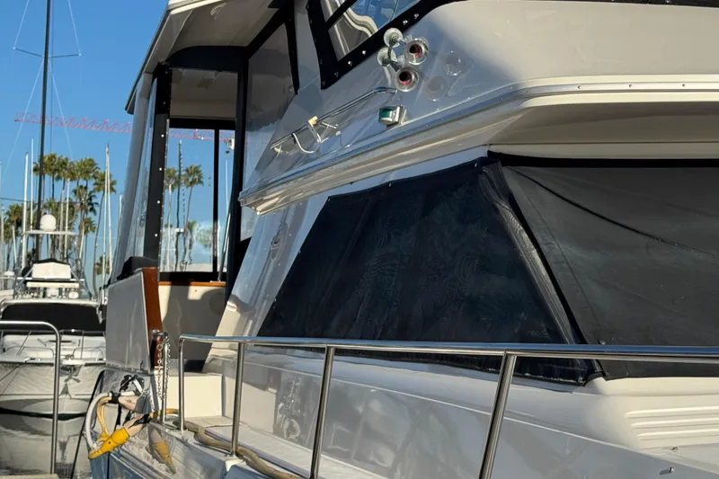 Slide: The Image of 1990 Sea Ray 380 Aft Cabin yacht docked at marina, side view. - 7