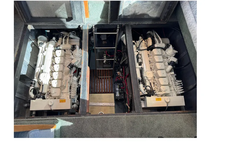 Slide: The Image of 1990 Sea Ray 380 Aft Cabin engine compartment with dual engines visible. - 70