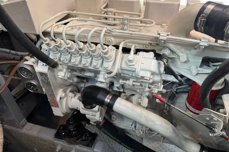 Slide: The Image of Engine compartment of a 1990 Sea Ray 380 Aft Cabin boat, showcasing mechanical components. - 71