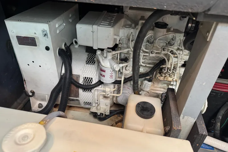 Slide: The Image of Engine compartment of a 1990 Sea Ray 380 Aft Cabin boat, showing mechanical components. - 73