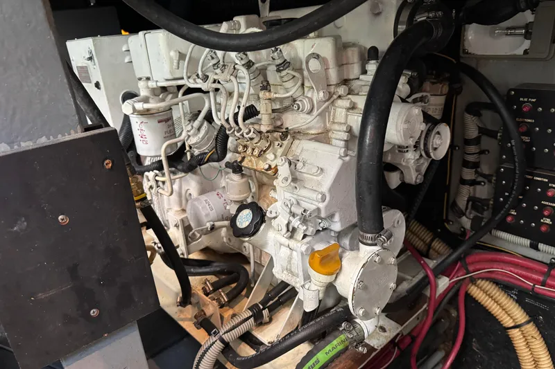 Slide: The Image of Engine compartment of a 1990 Sea Ray 380 Aft Cabin boat, showcasing mechanical components. - 74