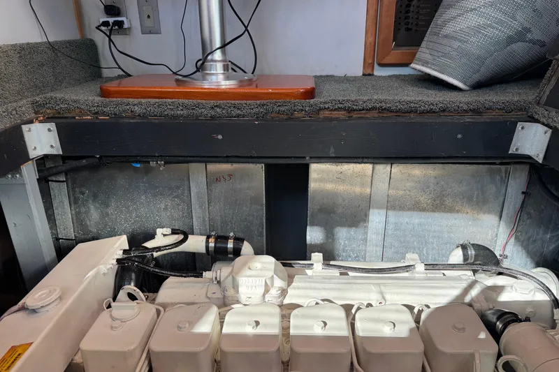 Slide: The Image of 1990 Sea Ray 380 Aft Cabin engine compartment with visible components and wiring. - 75