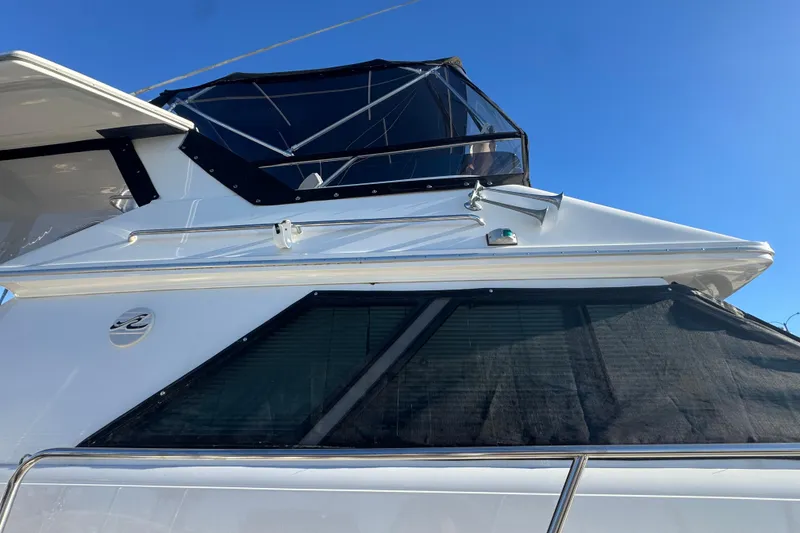 Slide: The Image of 1990 Sea Ray 380 Aft Cabin yacht with sleek design and tinted windows. - 8