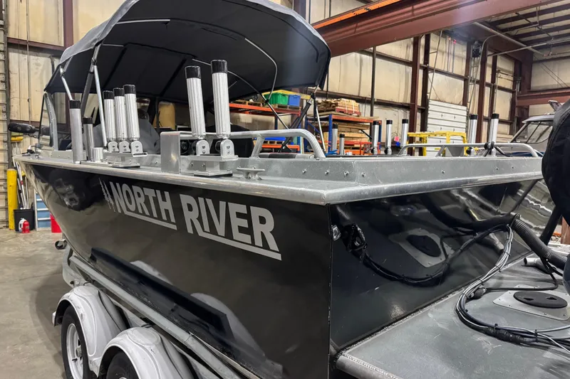 Slide: The Image of 2008 North River 21 SEAHAWK boat in a warehouse, featuring multiple rod holders. - 10