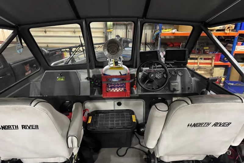 Slide: The Image of 2008 North River 21 SEAHAWK boat interior with steering wheel and navigation equipment. - 16