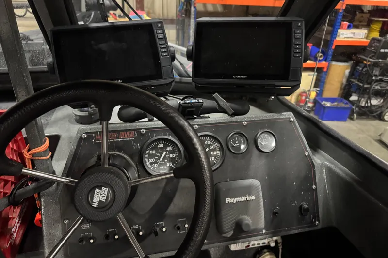 Slide: The Image of 2008 North River 21 SEAHAWK boat dashboard with Garmin and Raymarine displays. - 17
