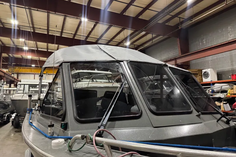 Slide: The Image of 2008 North River 21 SEAHAWK boat in a warehouse, featuring a covered cabin. - 2