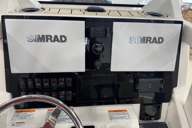 Slide: The Image of 2021 Yamaha Boats 255 FSH Sport E dashboard with dual Simrad displays and controls. - 8